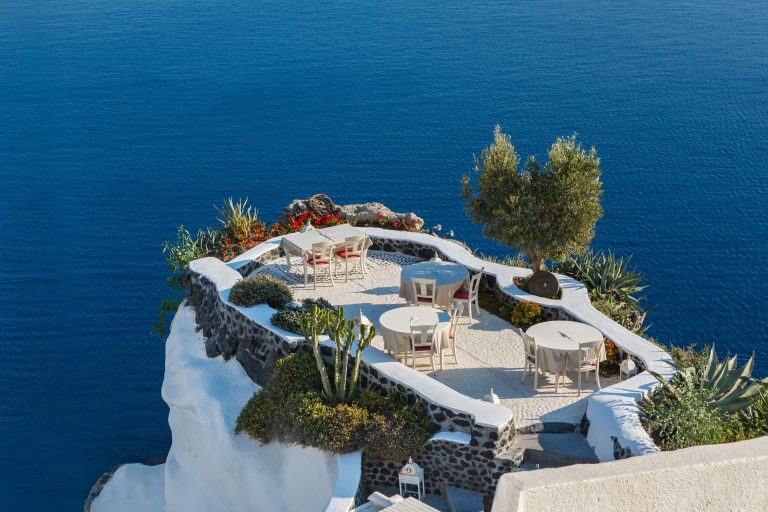 Empty tables in a restaurant over the sea